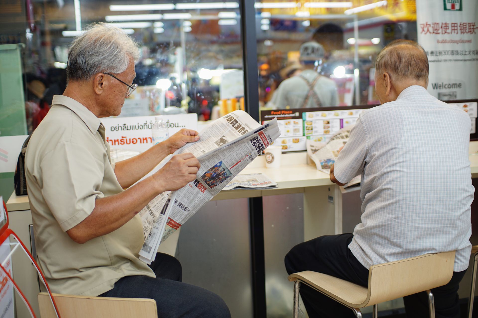 A newspaper reader in a cafe