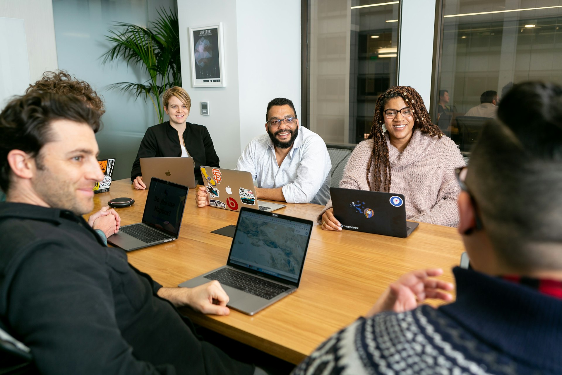 A team meeting around a laptop