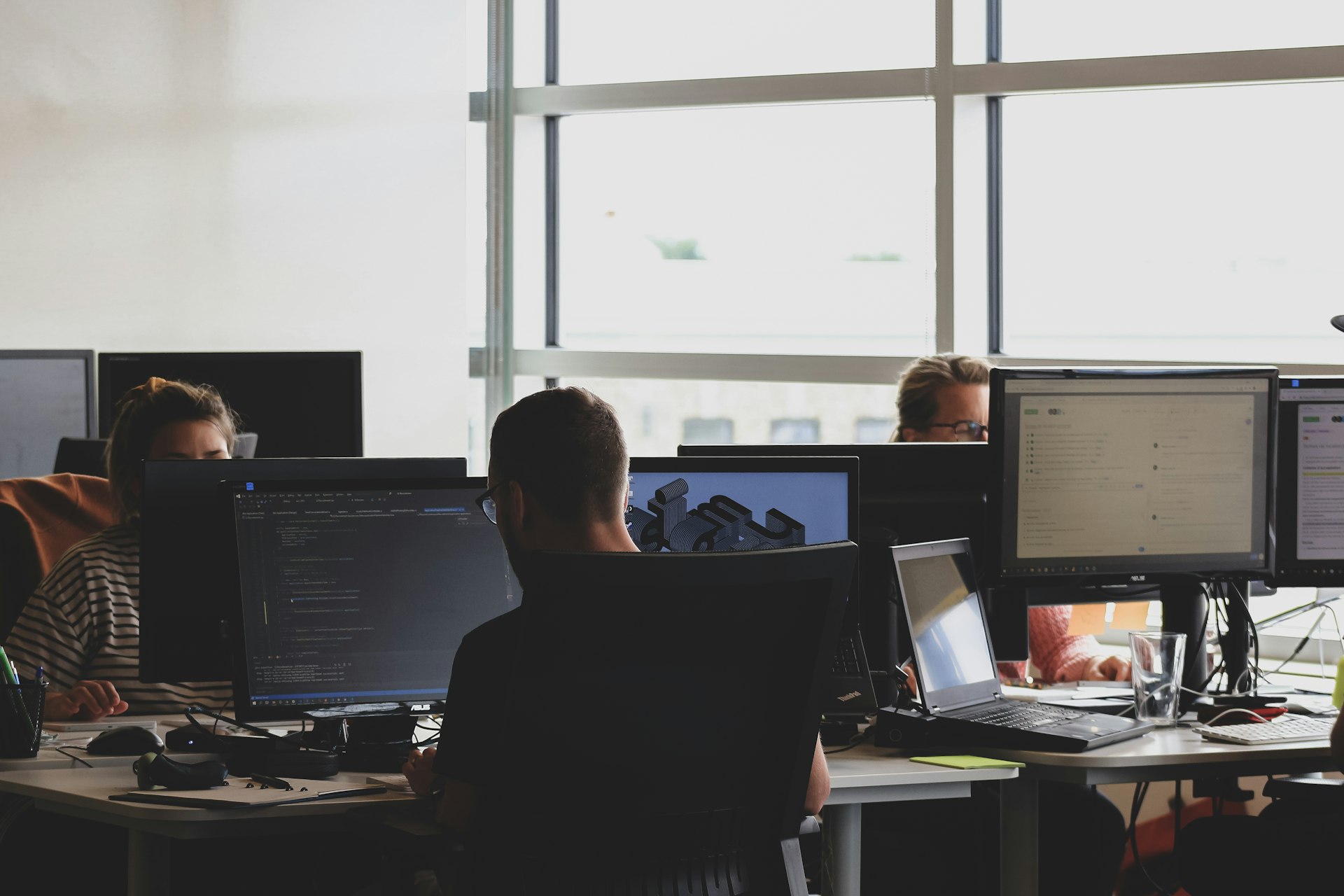 A developer at two screens
