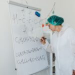 An analyst writing on a whiteboard