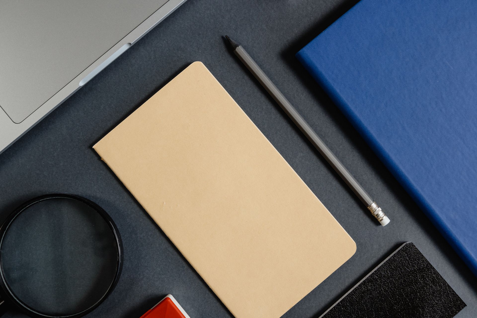 A notebook beside a laptop