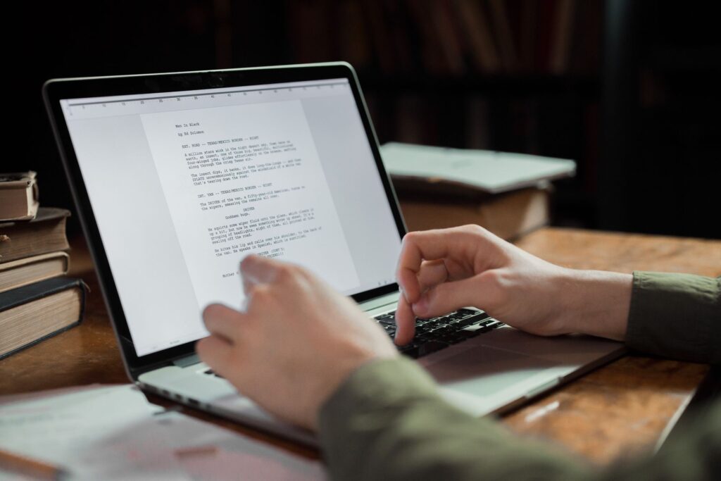 A writer typing on a laptop