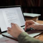 A writer typing on a laptop