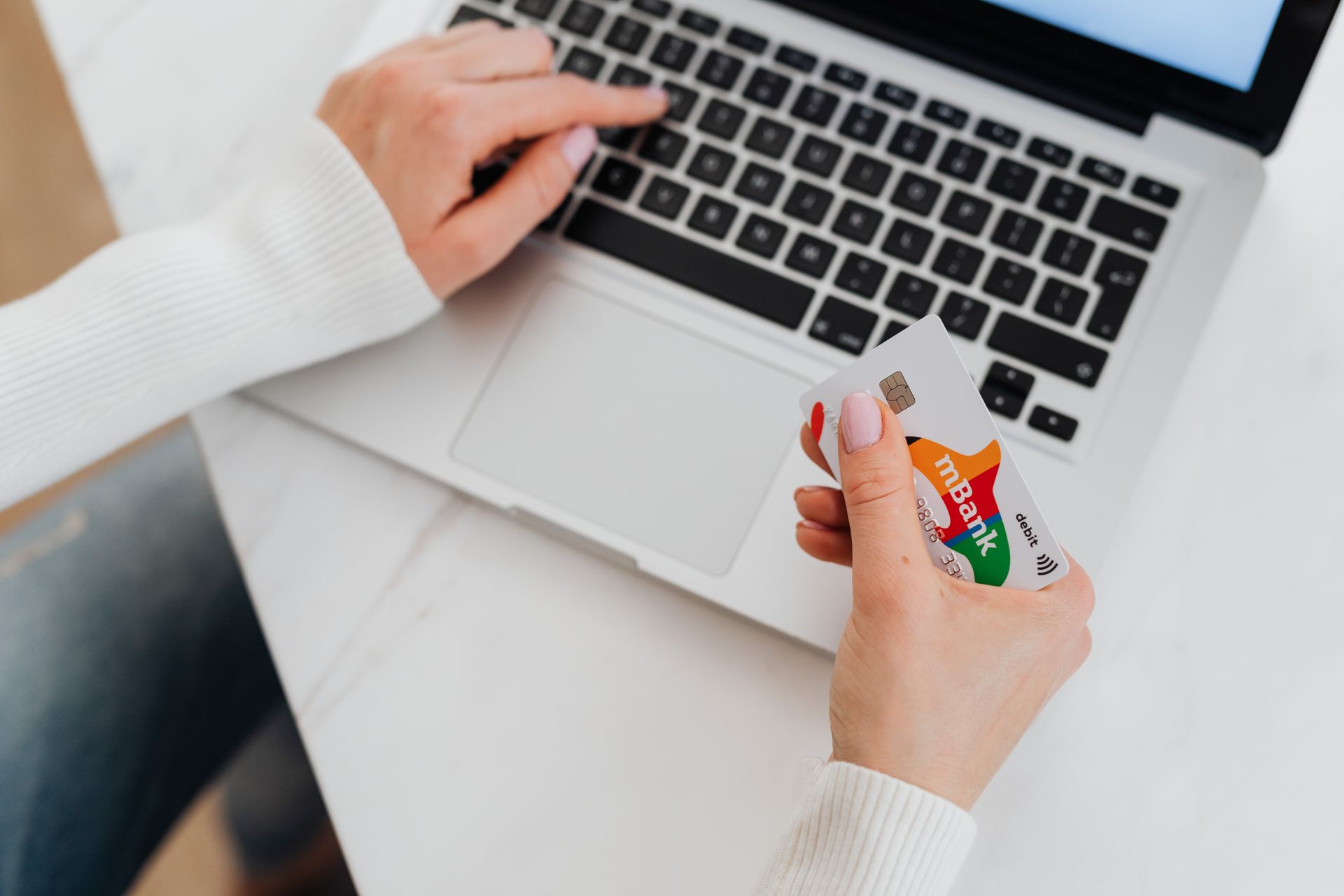 A bank card beside a laptop