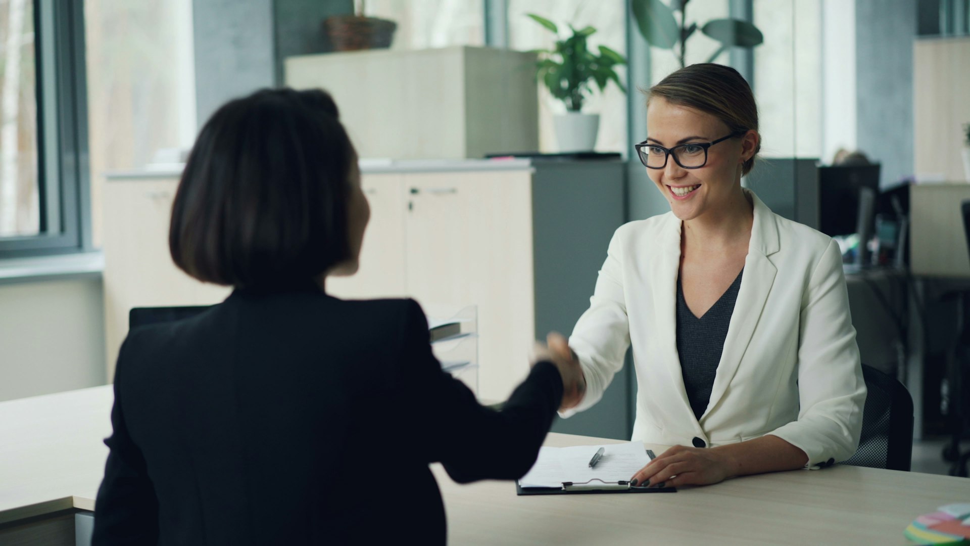 A handshake over a desk