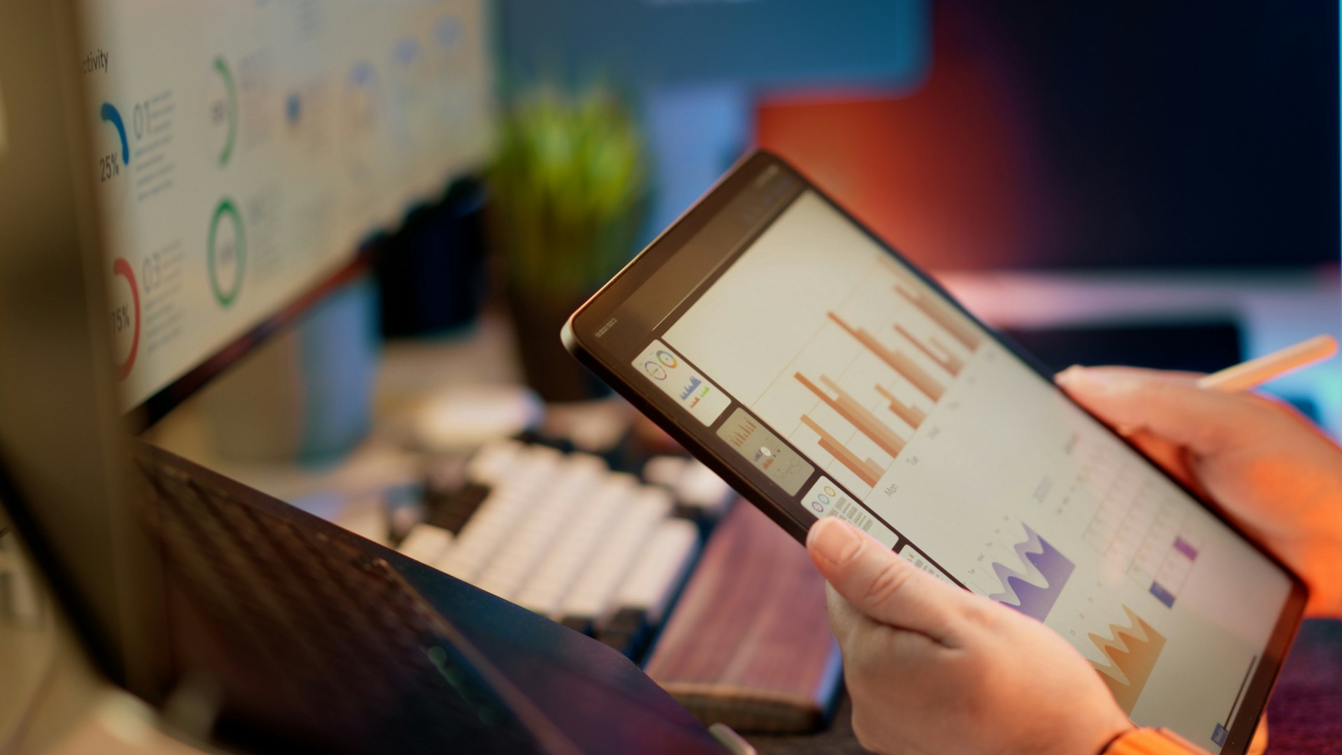 An analyst comparing two tools on two screens