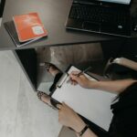 A technical SEO checklist on a clipboard beside a laptop