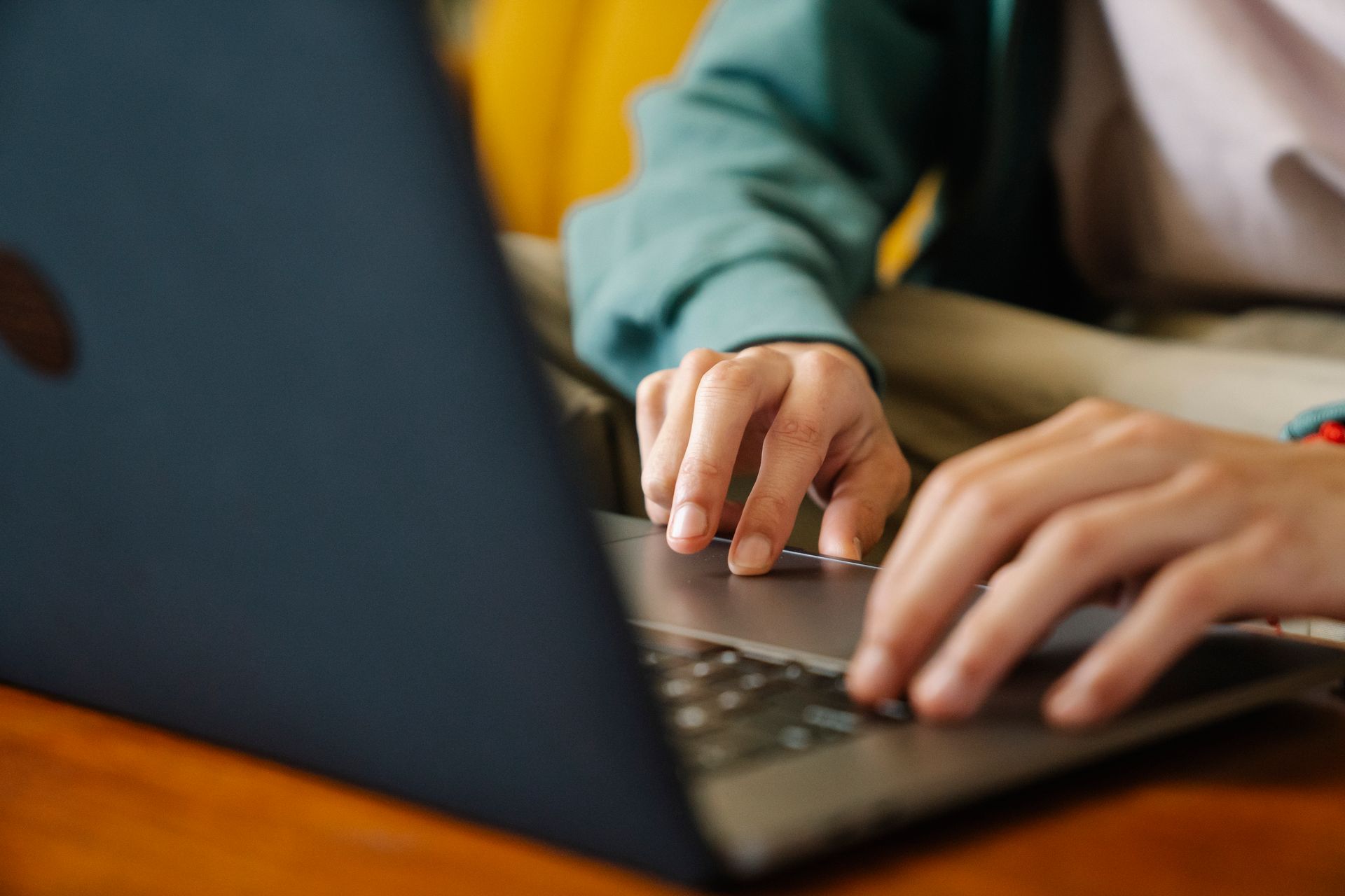 A person typing a headline on a laptop