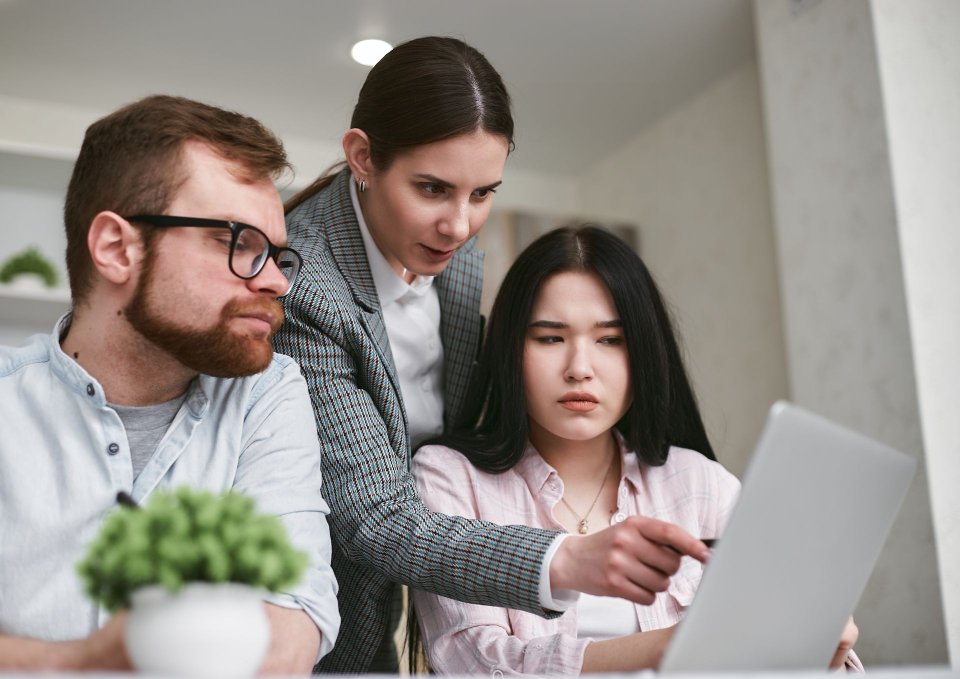 A team discussing a laptop screen
