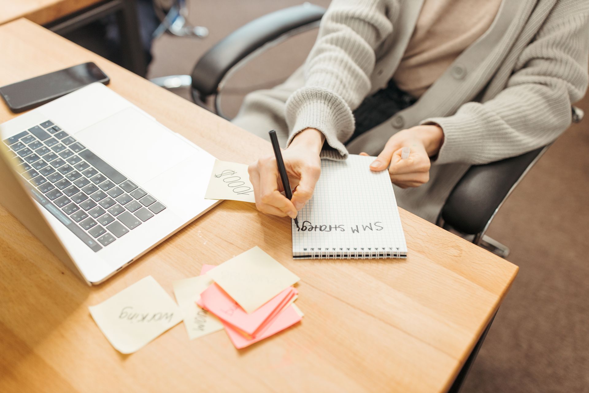 A marketer with a laptop and notes