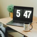 A calendar beside a laptop
