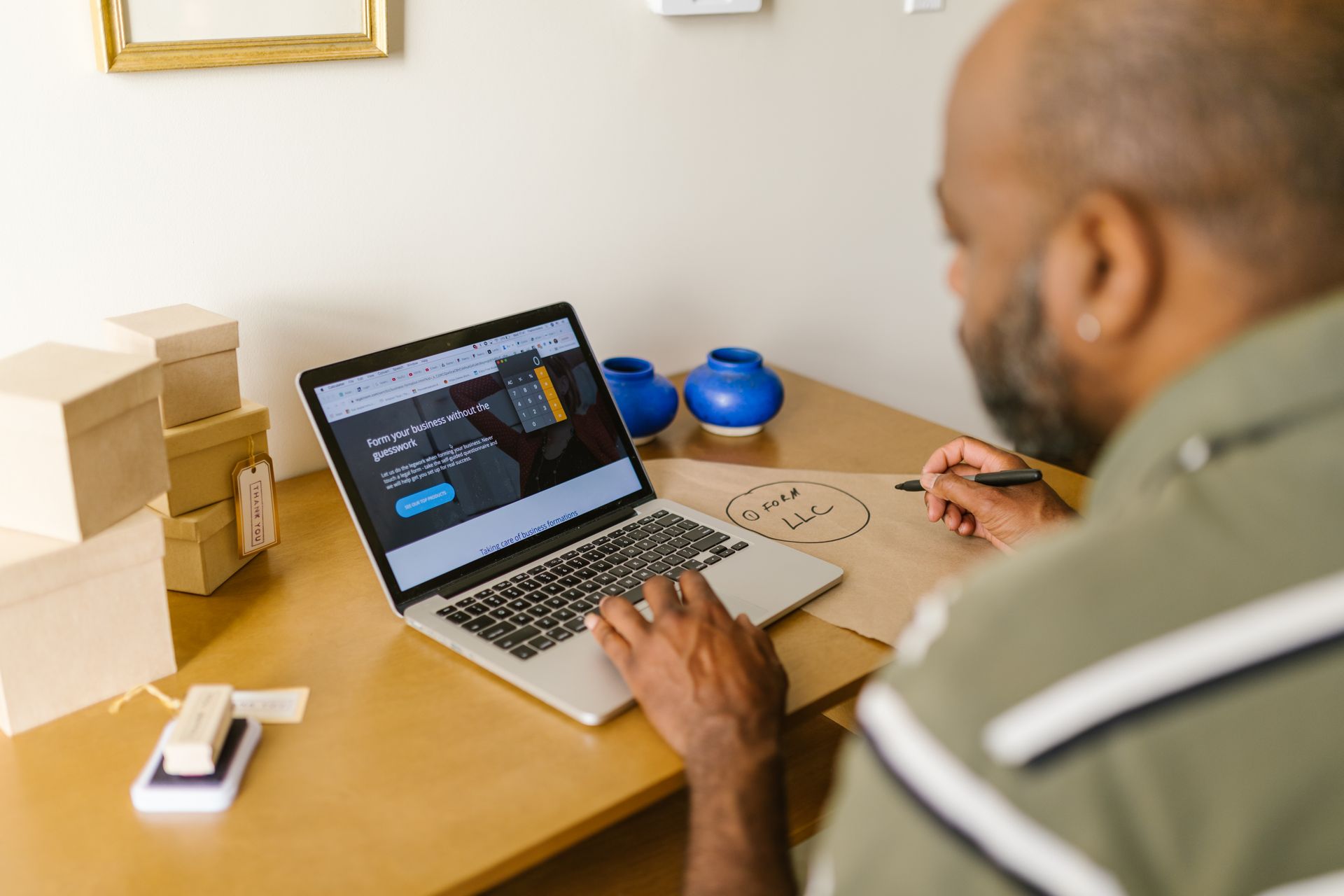 A small business owner at a laptop