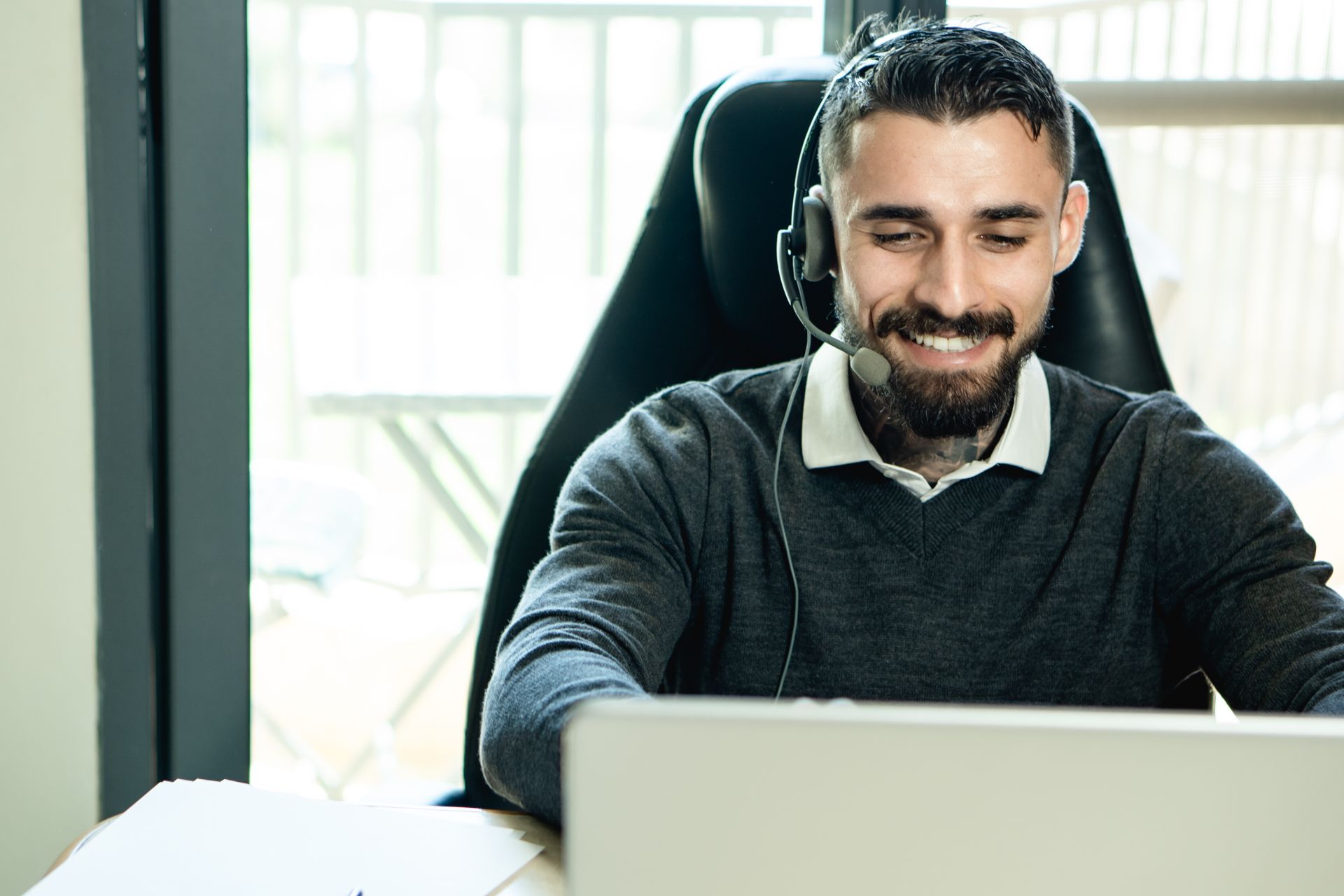 A customer smiling at laptop