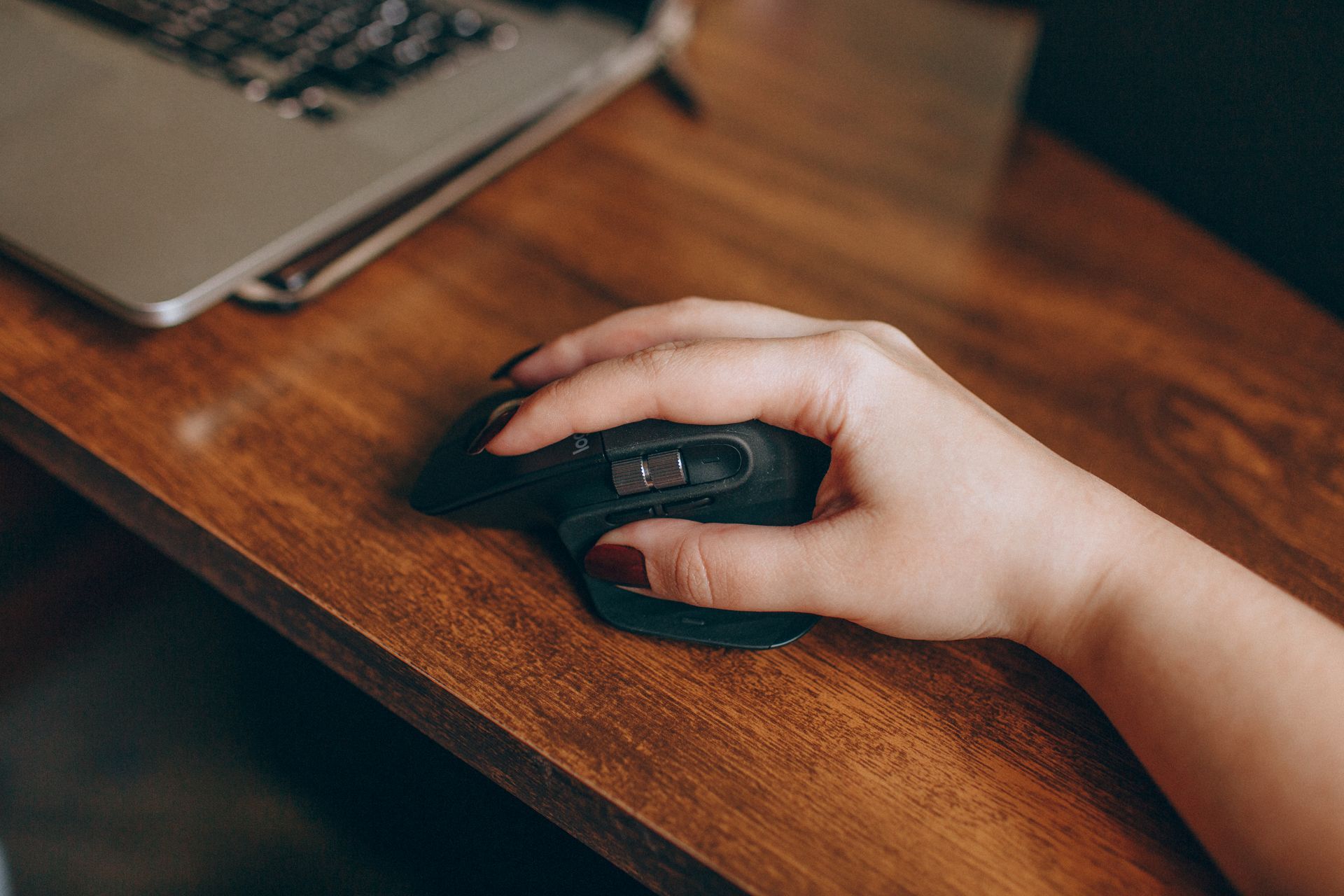 A person clicking mouse at desk