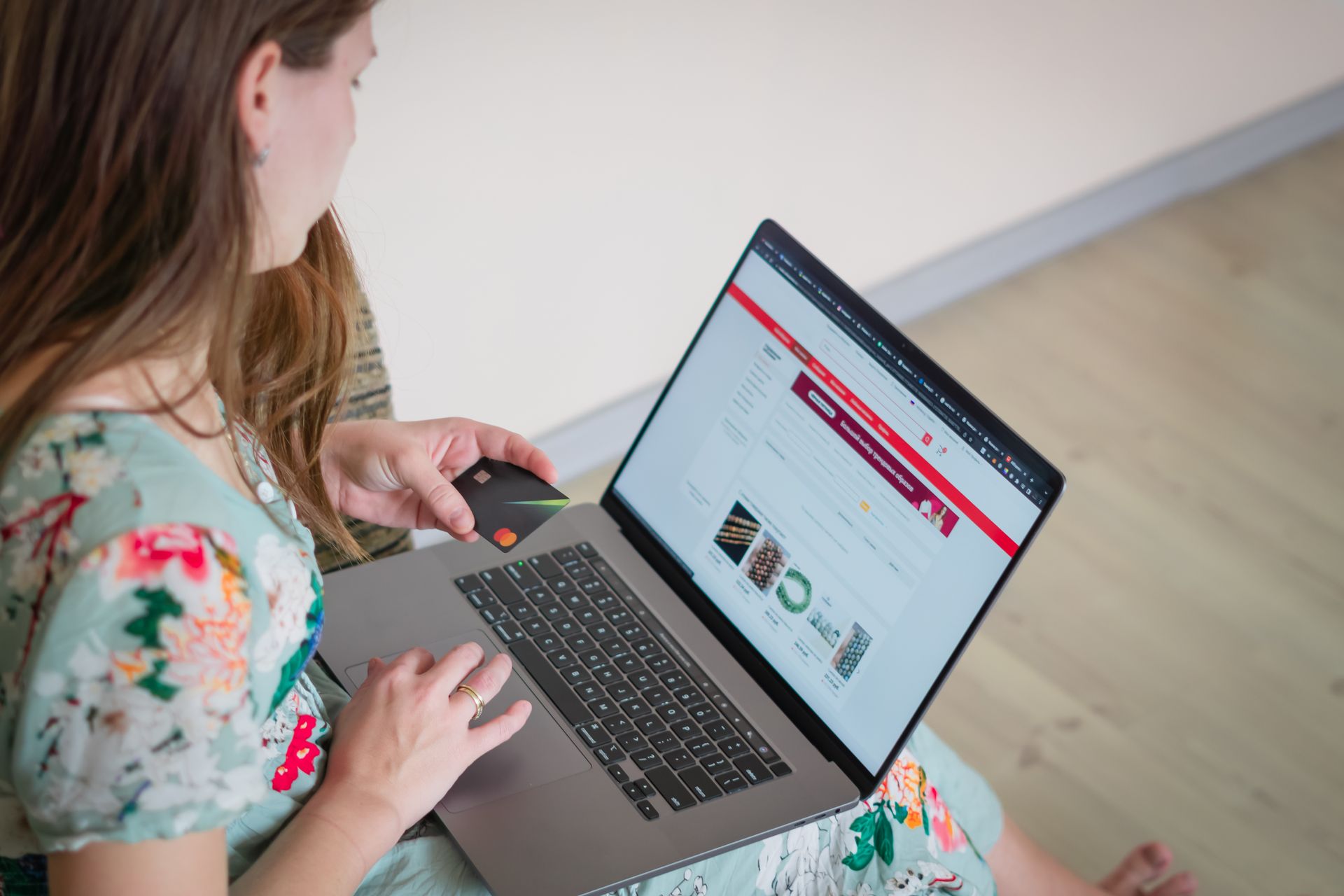 A woman browsing a website on a laptop